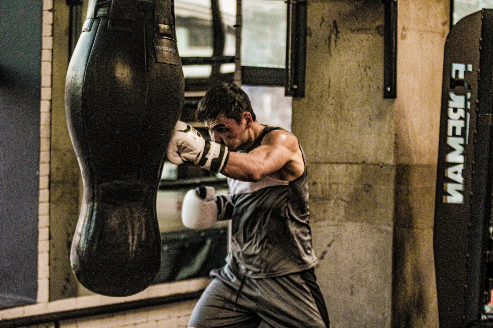 Boxer training on a heavy bag in a gym